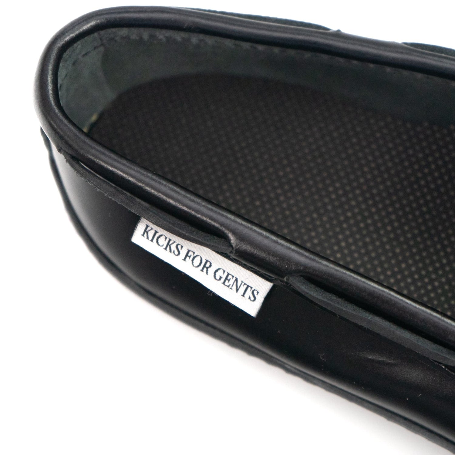 3 pairs of kicks for gents loafers sitting on a concrete ledge a man grabbing the pair in the back (tweed tassel loafers) LIMITED INVENTORY MEN'S - Kicks For Gents